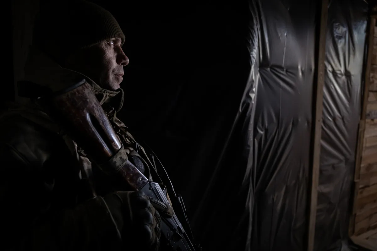A member of Ukraine's 124th Marine Brigade stands watch at an infantry position in the city of Kherson, southern Ukraine, 16 November 2024. Photo: EPA-EFE / MARIA SENOVILLA