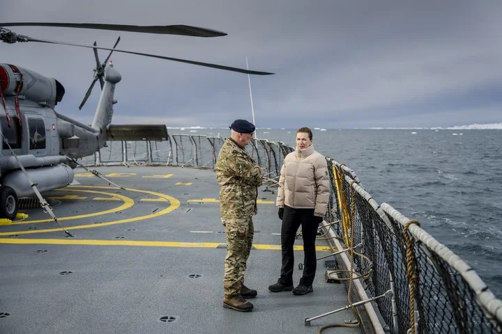 Danish Prime Minister Mette Frederiksen (R) talks with the chief of the Arctic Command, Soeren Andersen, on a Danish Navy vessel near Nuuk, Greenland, 3 April 2025. Photo: EPA /Mads Claus Rasmussen