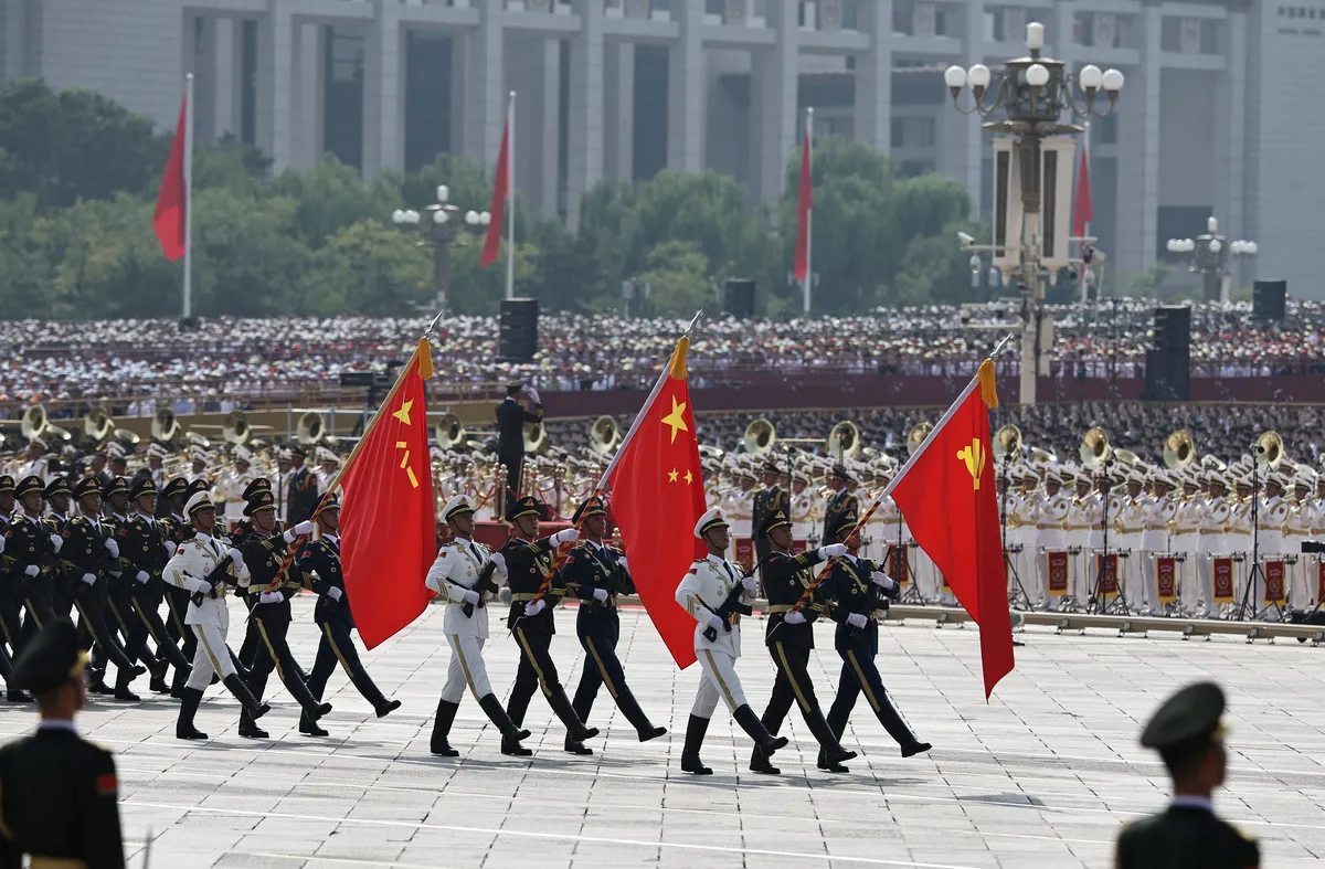 Chinese troops march with the flags of North Korea, China and the Soviet Union during the parade. Photo: EPA/WU HAO